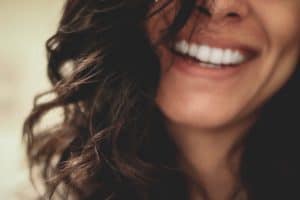 Close up of woman smiling.