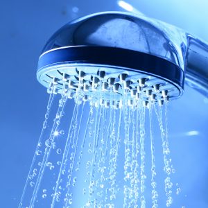 Shower head with water coming out.