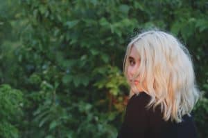 Blonde-haired woman looking back.