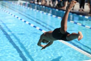 Person diving into a swimming pool