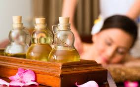 Bottles of oil with woman getting massage.