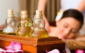 Bottles of oil with woman getting massage. 