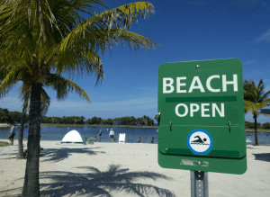 Open beach with sign.