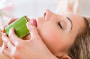 Woman getting an aloe vera facial treatment.