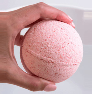 Hand holding bath bomb.