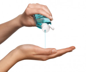 Person Pouring Liquid Soap Into Hand.