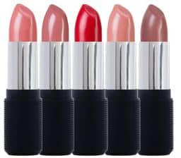 Lipsticks lined up with lids off.