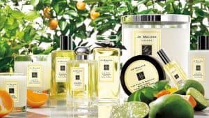 Assortment of Jo Malone products in front of orange tree. 