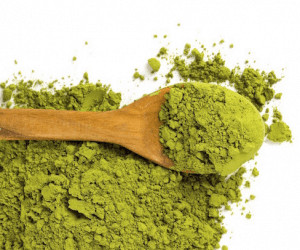 Matcha powder in wooden spoon.