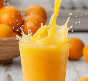 Glass of orange juice being poured.
