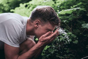 man washing his face.