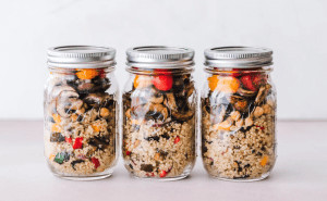 Three jars of quinoa with vegetables. 