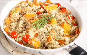 Quinoa in pan with fruits and vegetables.