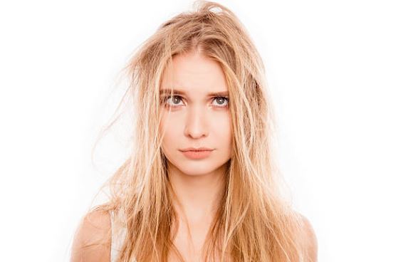 Blonde woman with messy, damaged hair.