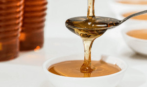 Honey dripping from spoon.