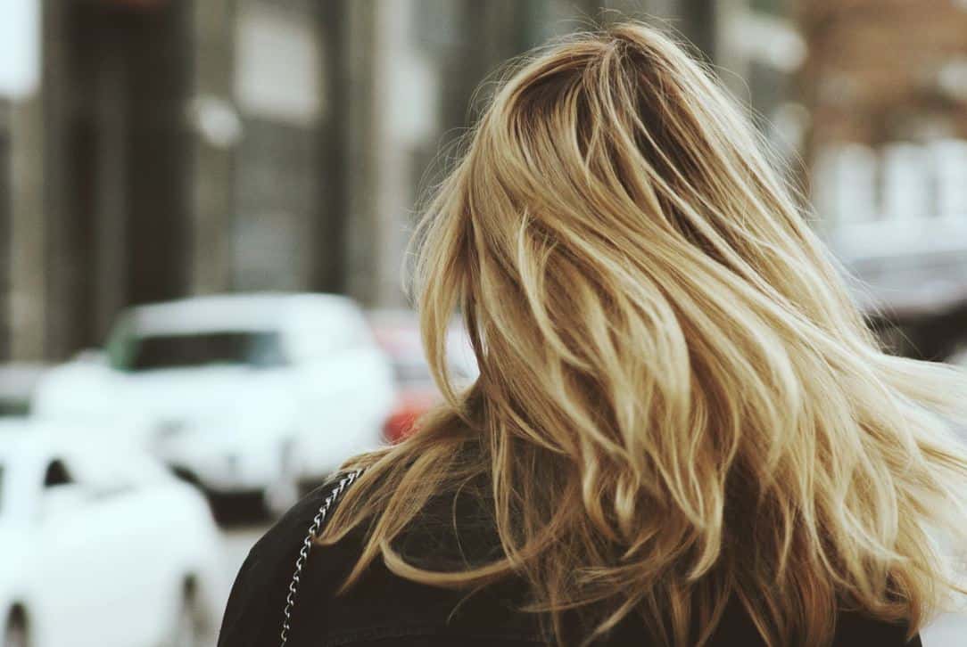 Blonde haired woman from behind.