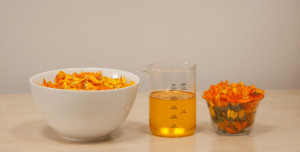 Bowls with flowers and beaker with oil. 