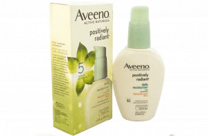 Bottle of aveeno positively radiant daily moisturizer next to packaging.