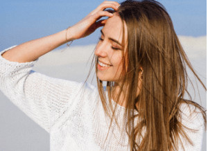 Woman running hands through her hair. 