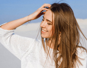 girl running fingers through her hair. 