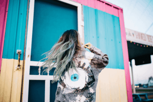 Woman with blue hair with back to camera.