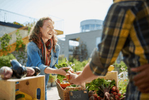 Woman buying fresh produce from farmers market.