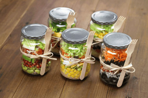 Mason jars filled with vegetables and fruit for meal prep.