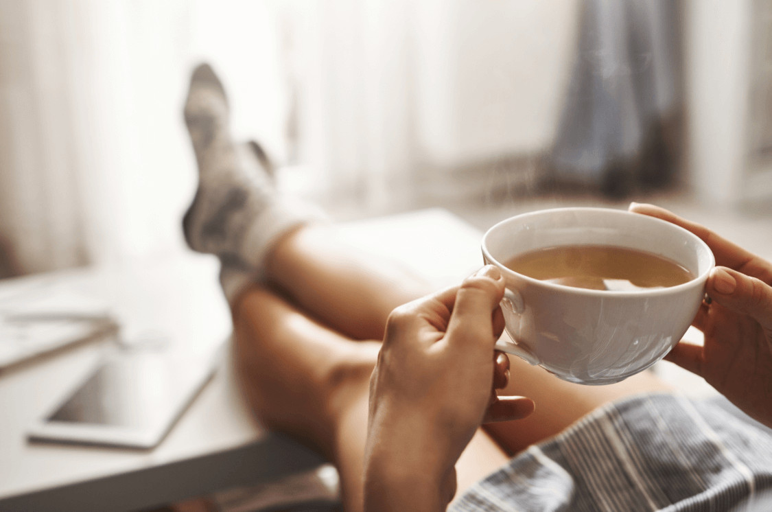 Hands holding tea.