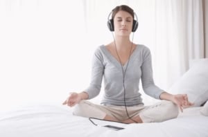 woman meditating with app