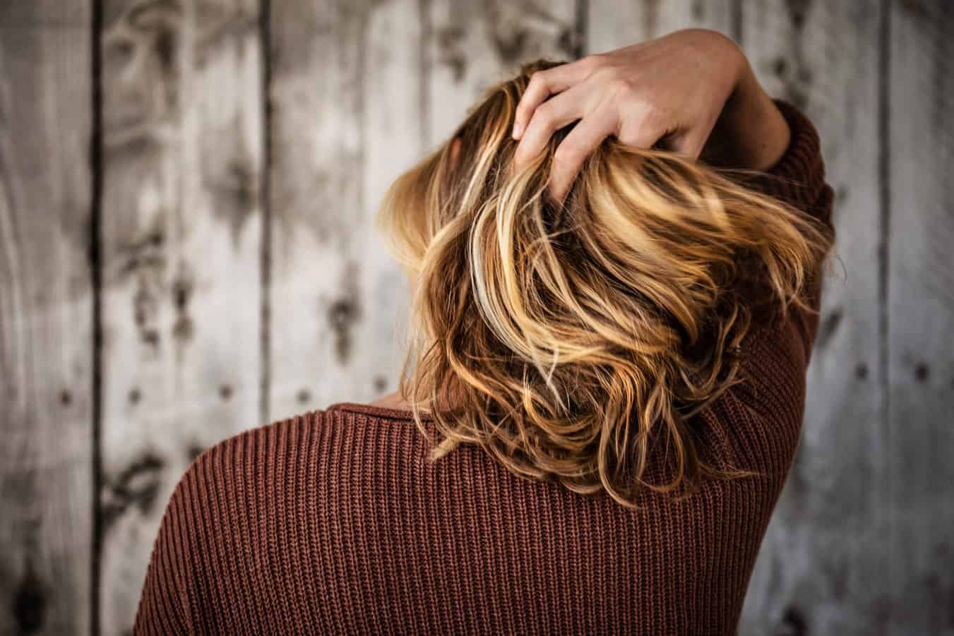 Back of woman with short blonde hair.