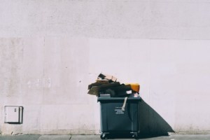 Garbage bin in the middle of street.