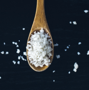 Spoon with salt on it.