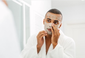 Man applying face mask to face.