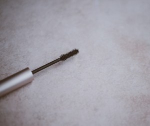 Mascara wand on table.