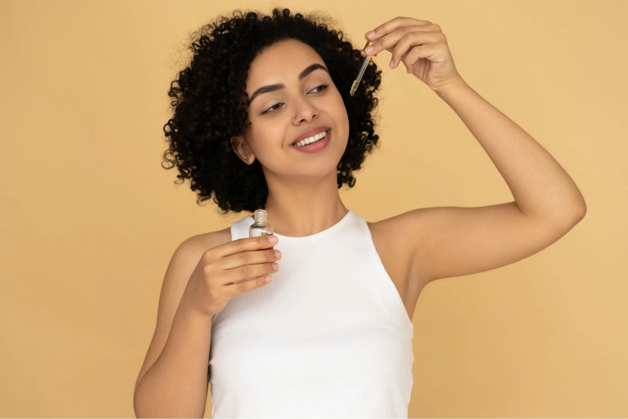 Woman using oil dropper.